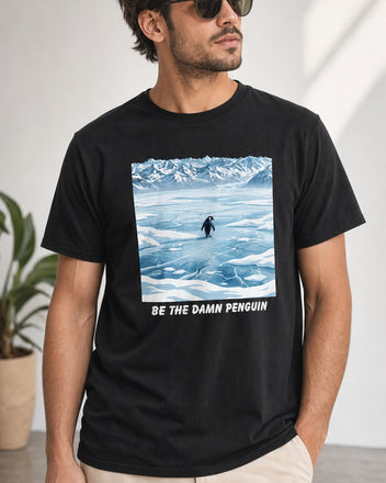 Be the Damn Penguin black graphic tee shown on a studio model