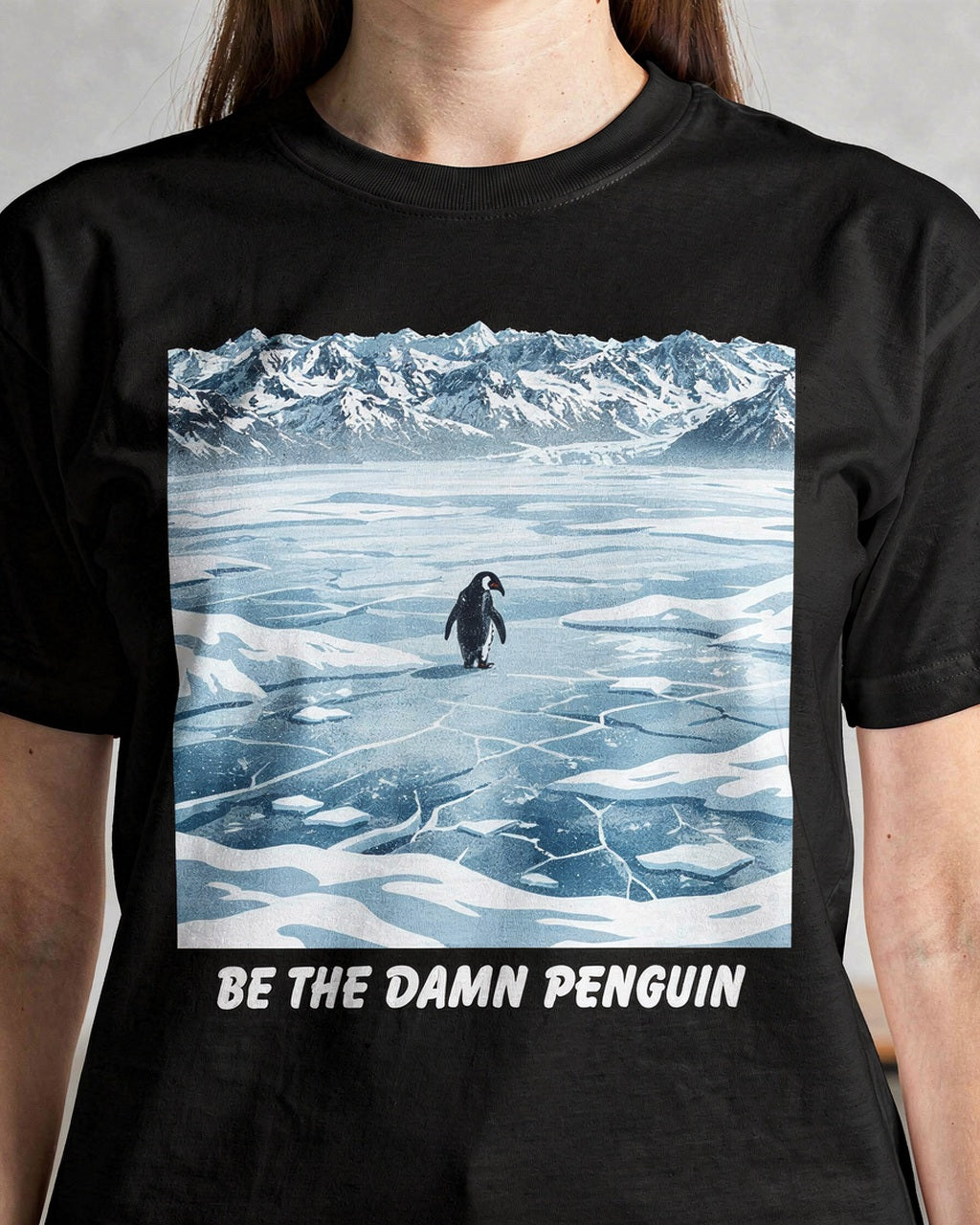 Close-up of the Be the Damn Penguin artwork on a black T-shirt