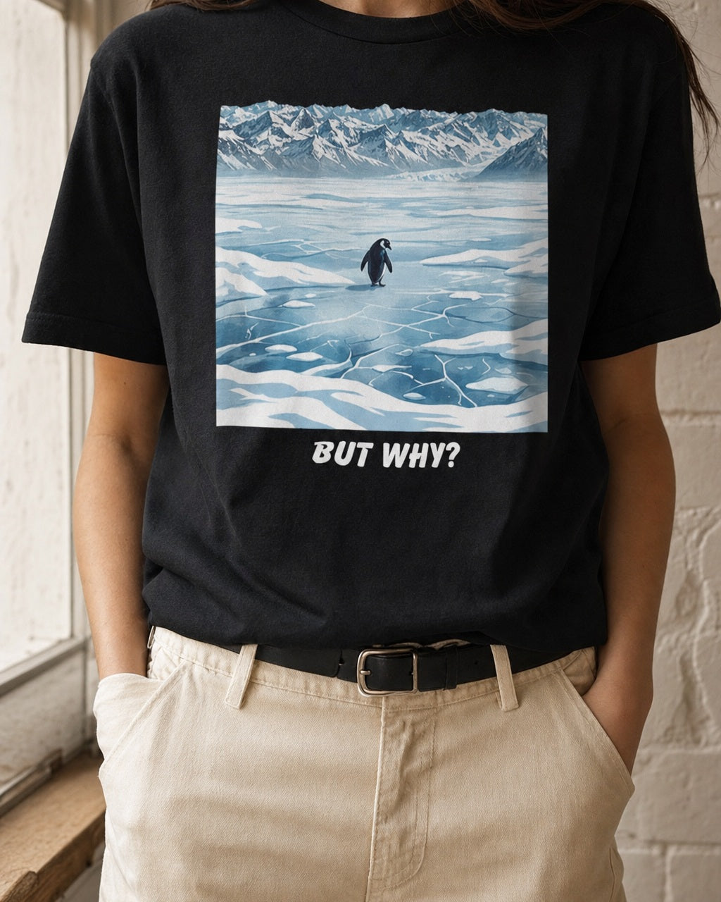 Close-up of the But Why Penguin artwork on a black T-shirt