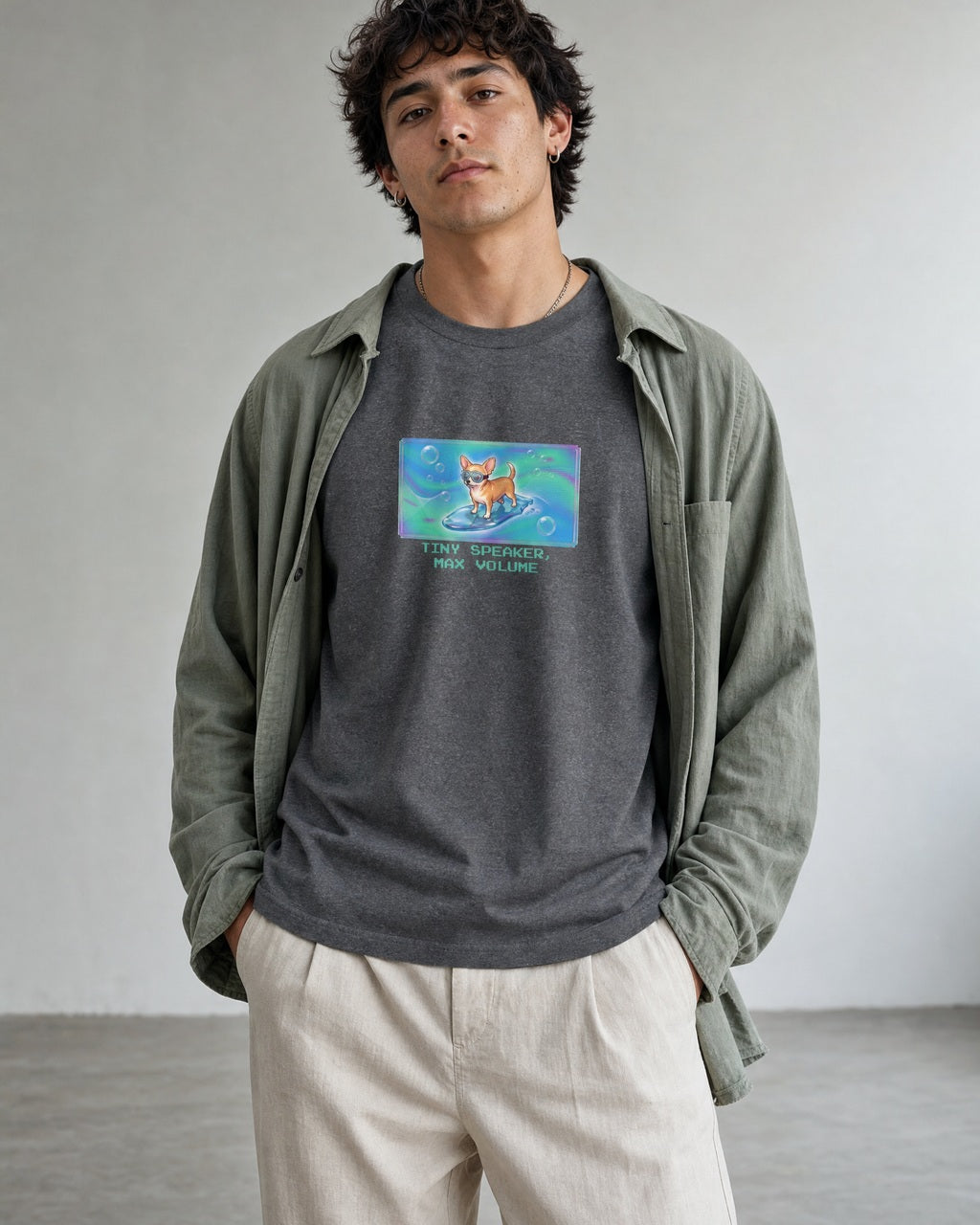 O's Tees Tiny Speaker, Max Volume Chihuahua Frutiger Aero Dogs graphic tee lifestyle image — Graphite Heather shirt, male shot 01, stone trouser sage overshirt