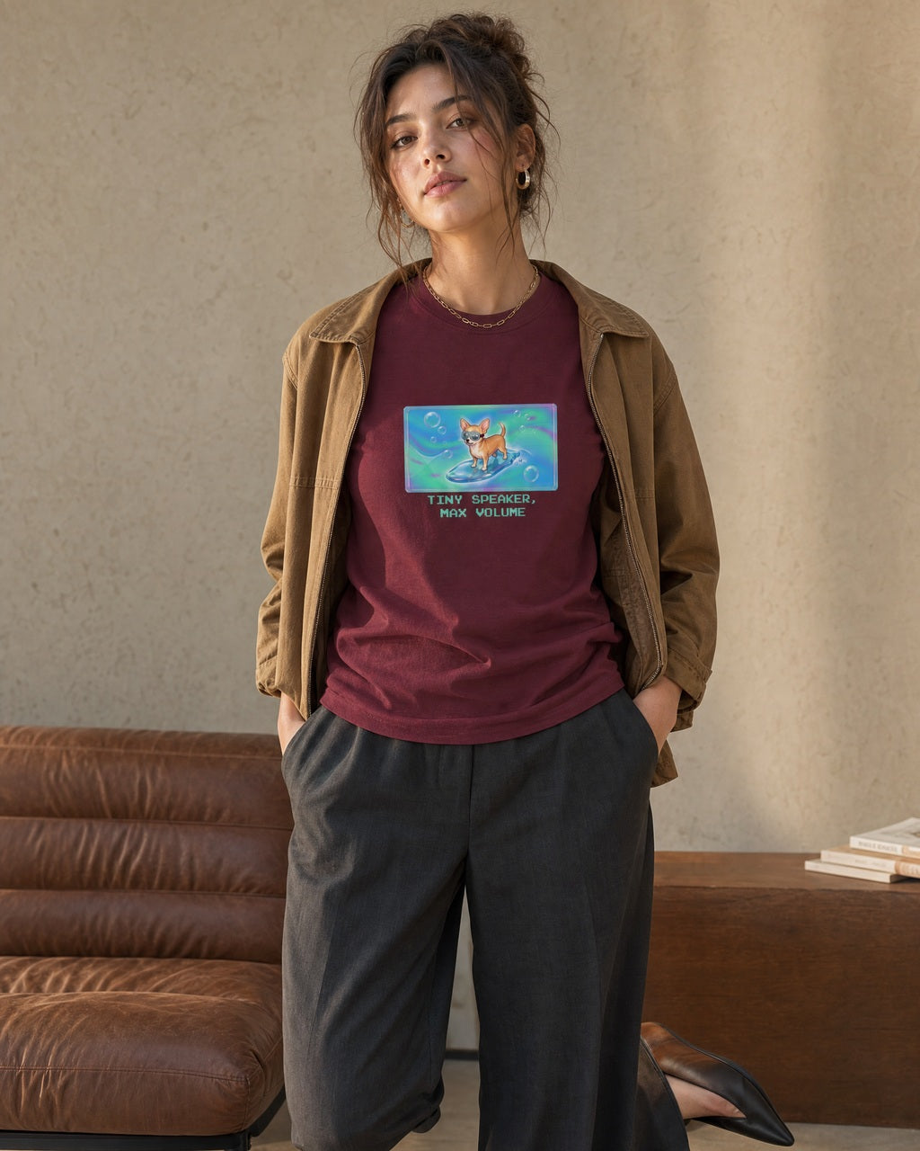 O's Tees Tiny Speaker, Max Volume Chihuahua Frutiger Aero Dogs graphic tee lifestyle image — Maroon shirt, female shot 02, charcoal trouser camel