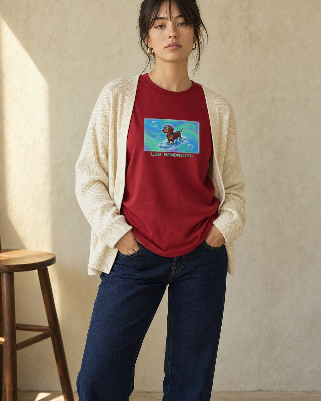 O's Tees Low Bandwidth Dachshund Frutiger Aero Dogs graphic tee lifestyle image — Cardinal Red shirt, female shot 01, dark indigo cream cardigan