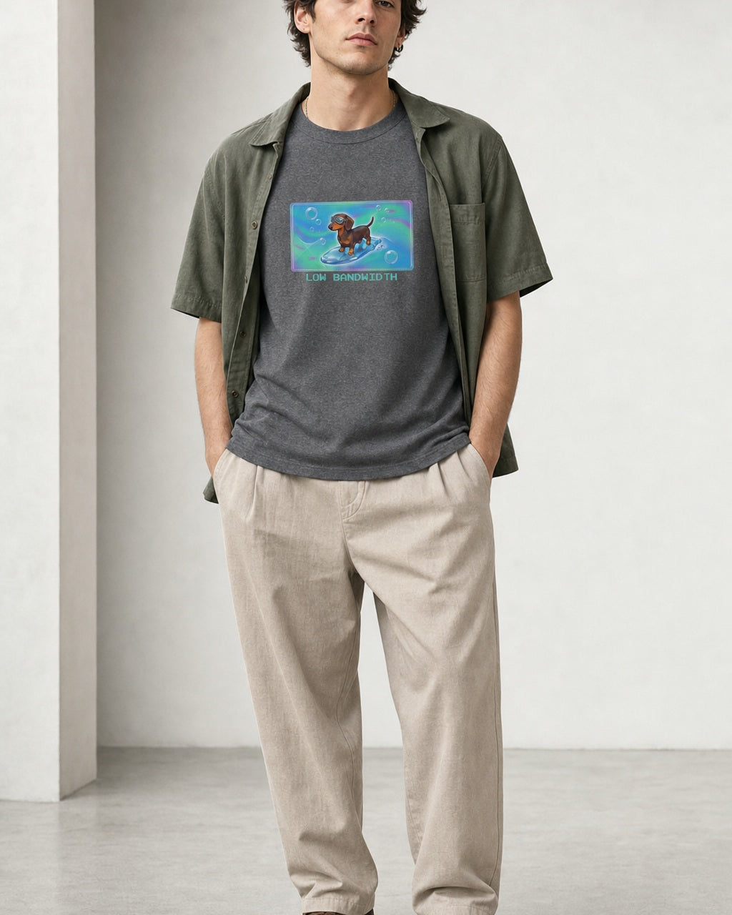 O's Tees Low Bandwidth Dachshund Frutiger Aero Dogs graphic tee lifestyle image — Graphite Heather shirt, male shot 01, stone trouser sage overshirt