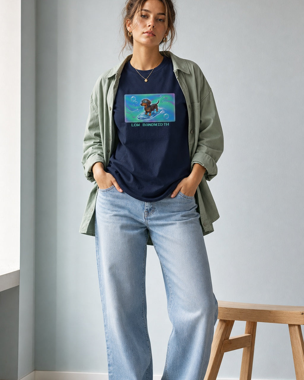 O's Tees Low Bandwidth Dachshund Frutiger Aero Dogs graphic tee lifestyle image — Navy shirt, female shot 02, lightwash sage