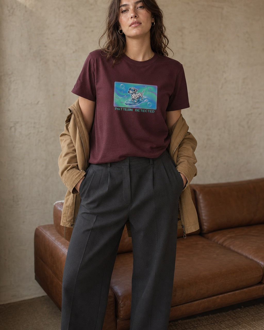 O's Tees Pattern Detected Dalmatian Frutiger Aero Dogs graphic tee lifestyle image — Maroon shirt, female shot 02, charcoal trouser camel