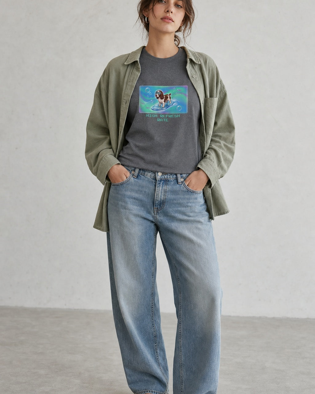 O's Tees High Refresh Rate English Springer Spaniel Frutiger Aero Dogs graphic tee lifestyle image — Graphite Heather shirt, female shot 01, washed blue denim sage