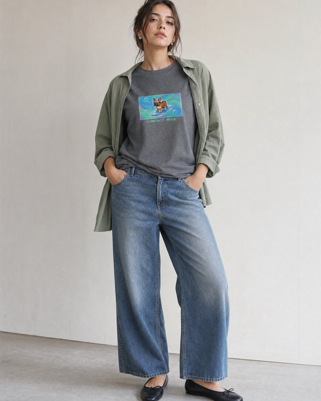 O's Tees Compact Mode French Bulldog Frutiger Aero Dogs graphic tee lifestyle image — Graphite Heather shirt, female shot 01, washed blue denim sage