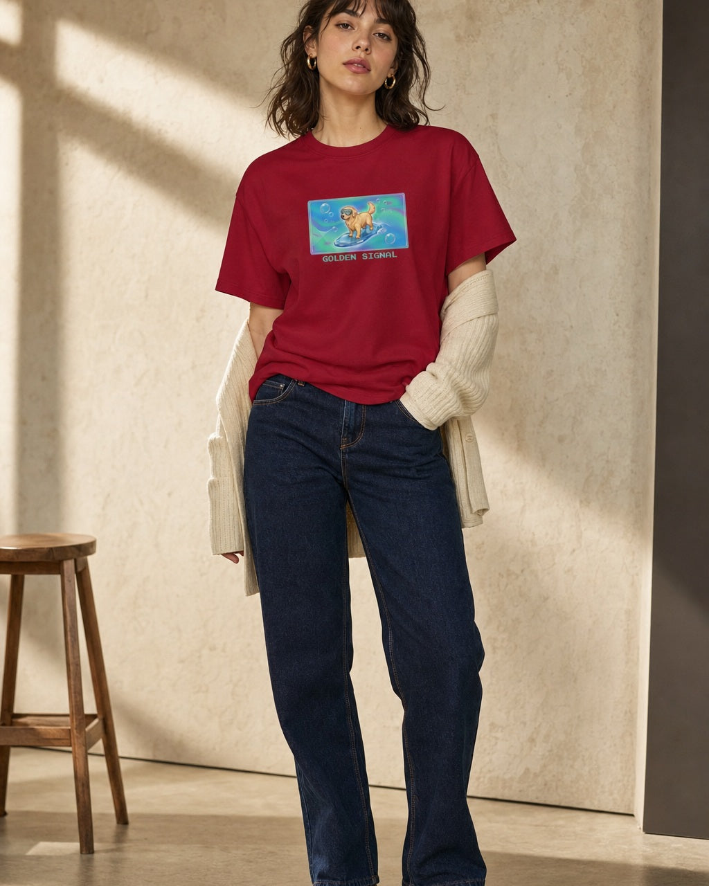 O's Tees Golden Signal Golden Retriever Frutiger Aero Dogs graphic tee lifestyle image — Cardinal Red shirt, female shot 01, dark indigo cream cardigan